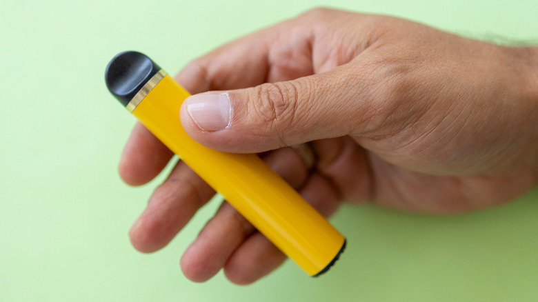 yellow e-cigarette against green background