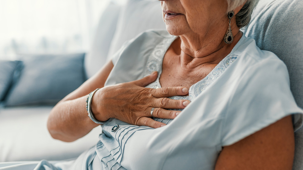 Woman holding chest pain