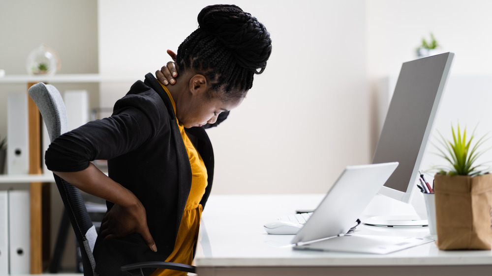 Woman holding back pain