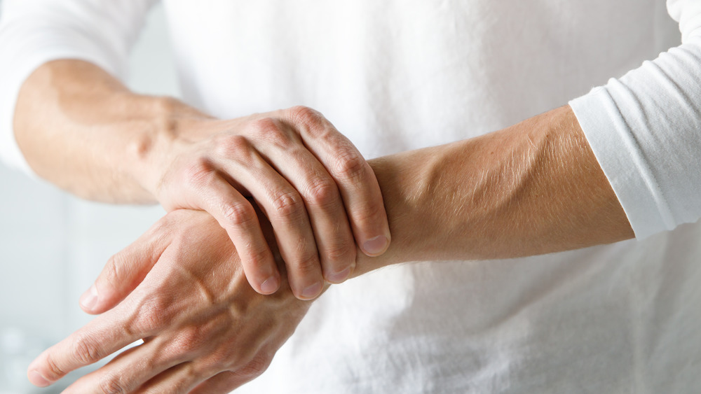Woman holding wrist joint pain