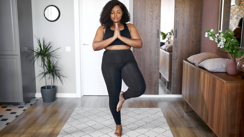 woman balancing in tree pose