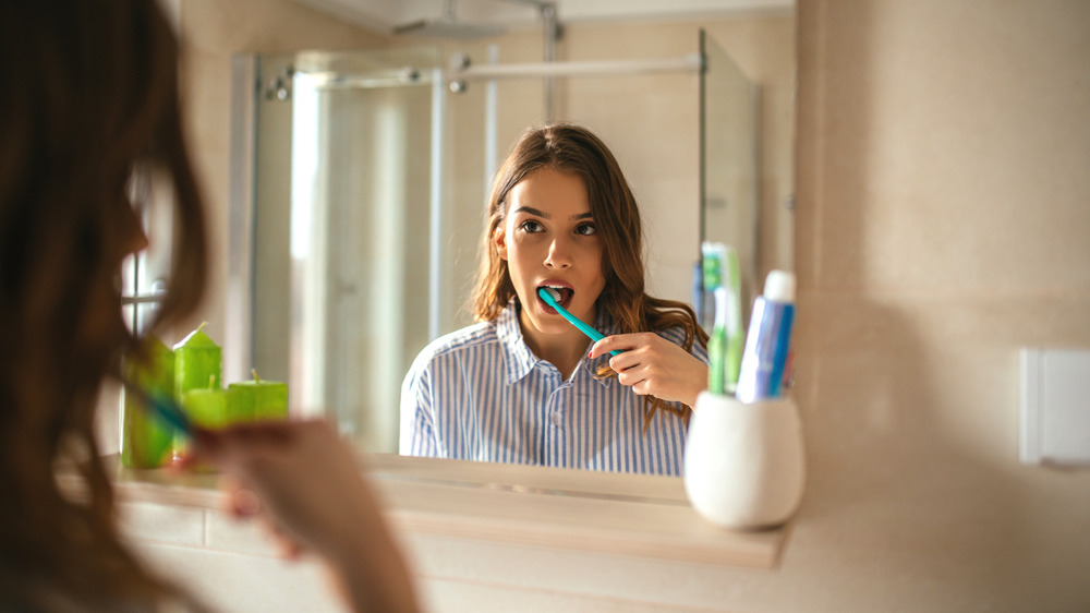 woman brushing teeth