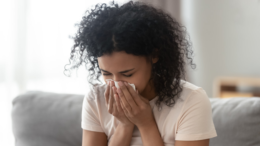 Woman blowing her nose