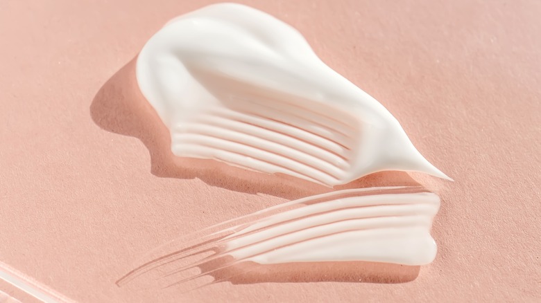 white sunscreen on pink background