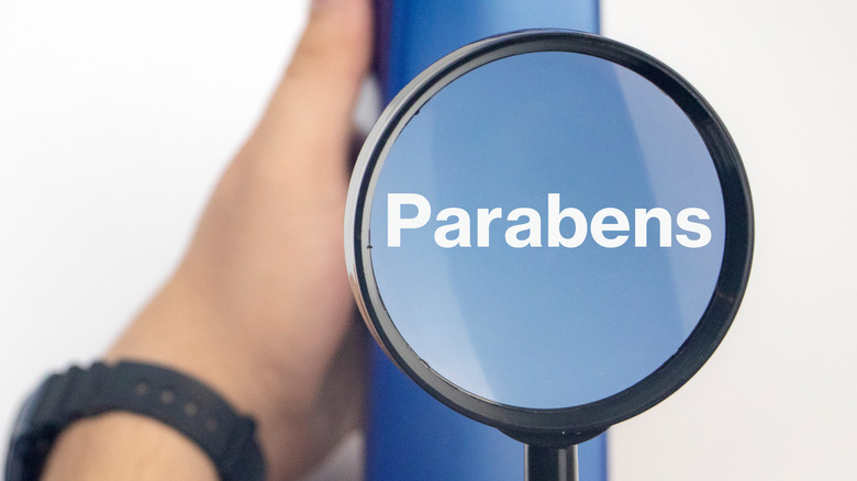 parabens in lotion under magnifying glass