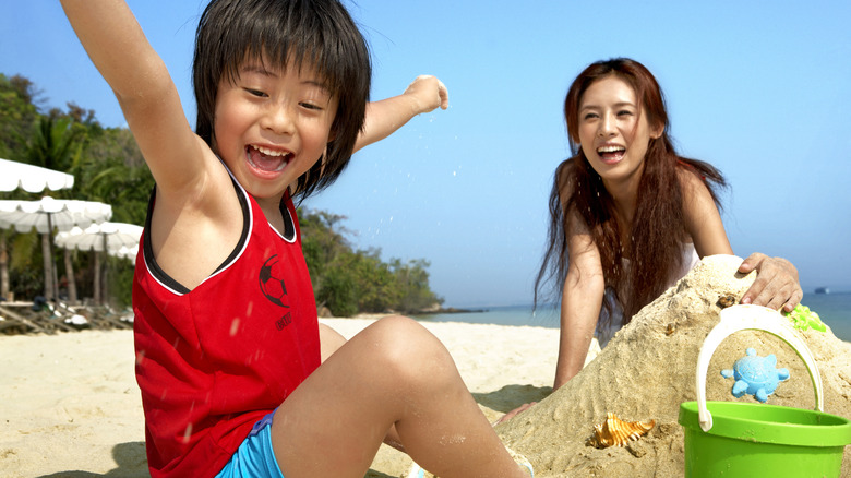 young boy playing in sand