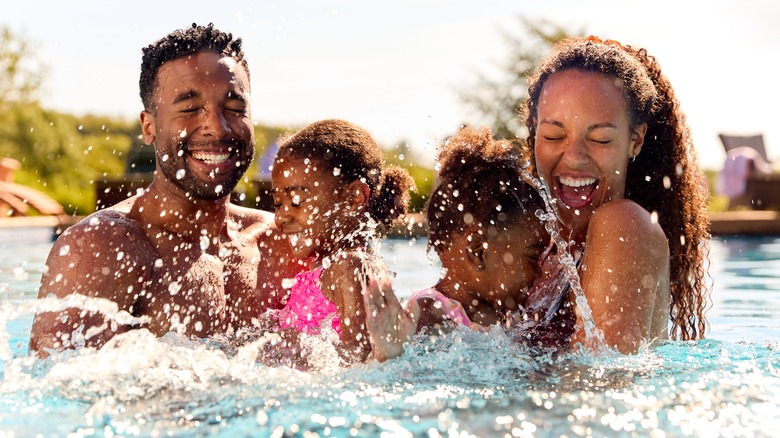 family splashing in pool