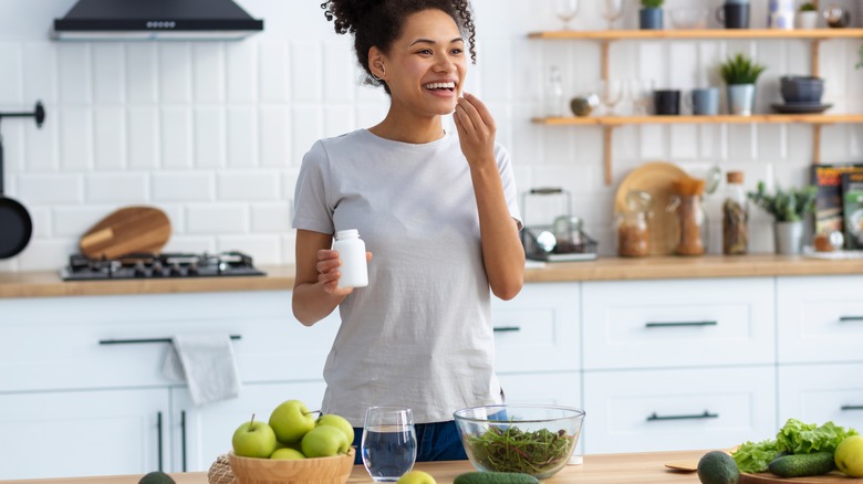 woman taking meds and following healthy diet