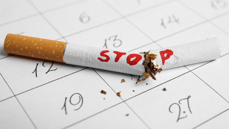 calendar with a broken cigarette that says "stop"