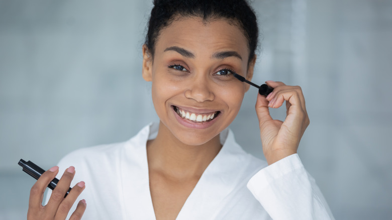 woman applying mascara