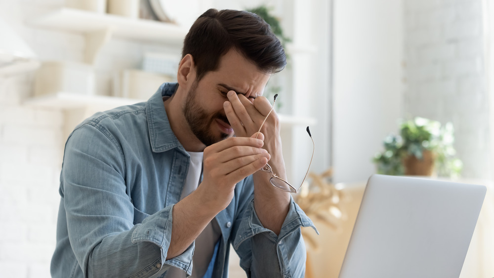 fatigued man on computer