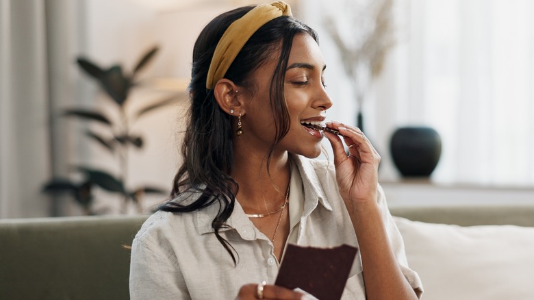 Woman eating dark chocolate