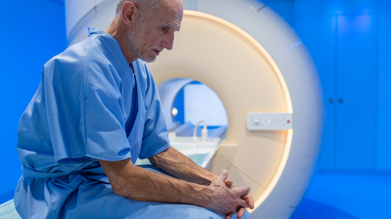 Nervous old man sitting on MRI