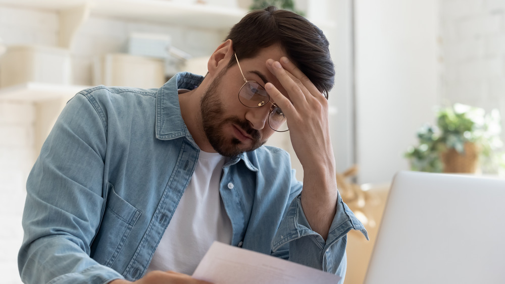 Stressed man on computer