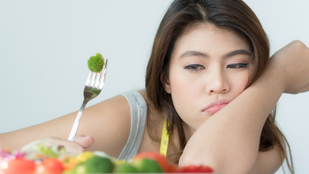 woman eating bland food without salt