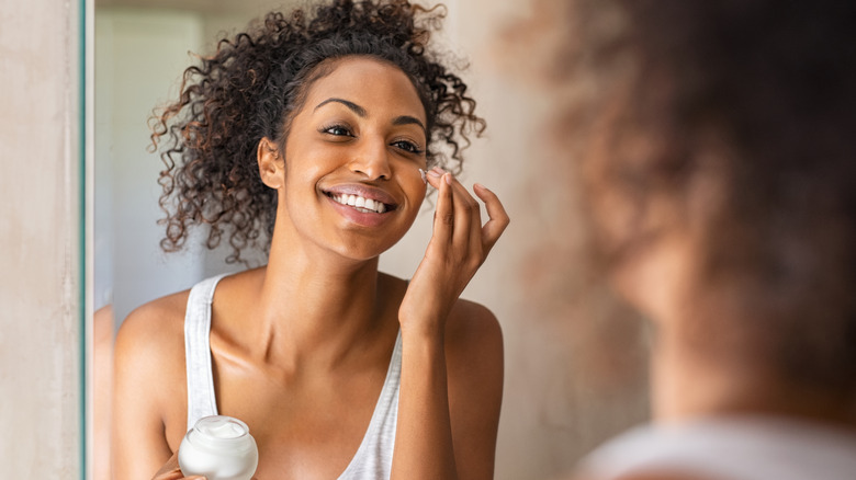 woman applying skin care cream