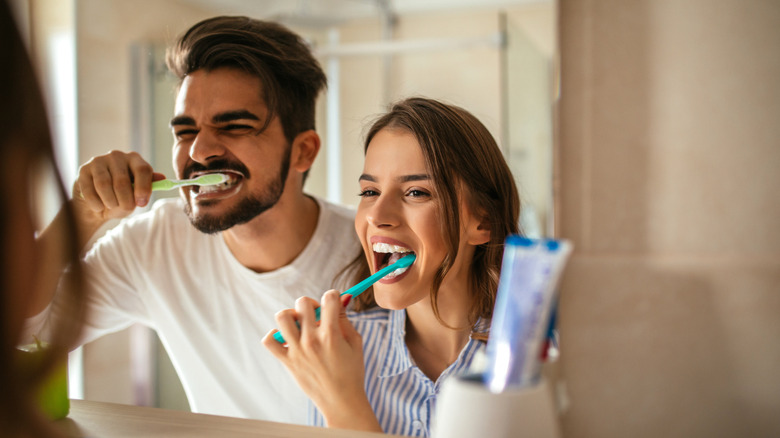 couple brushing teeth