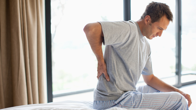 man waking up with back pain