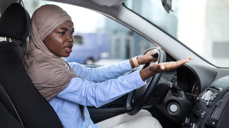 Woman sitting in her car during traffic