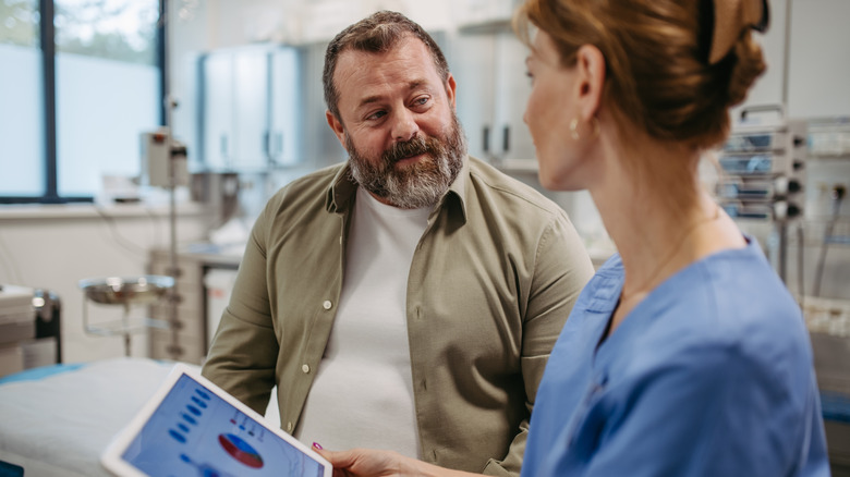 Man talking to his doctor in an exam room