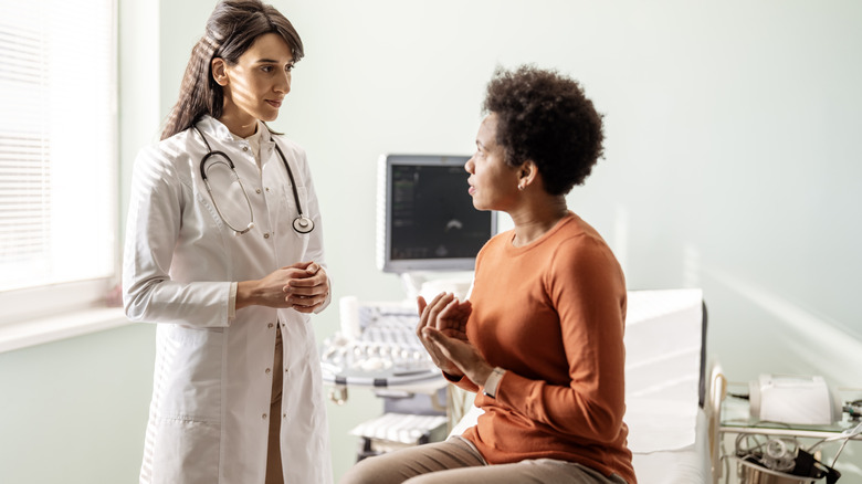 Woman speaking with her doctor in an office