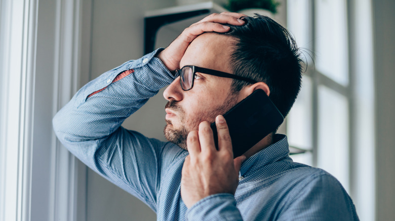 Stressed man talking on phone