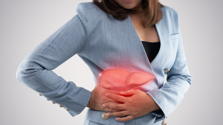 An image of a liver over a woman in a light blue blazer holding her side
