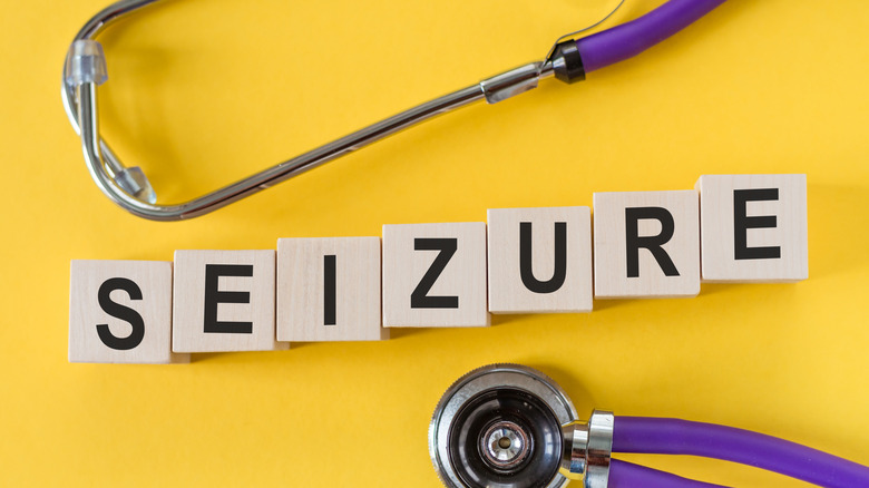 The word "seizure" spelled out in blocks surrounded by a stethoscope against a yellow background