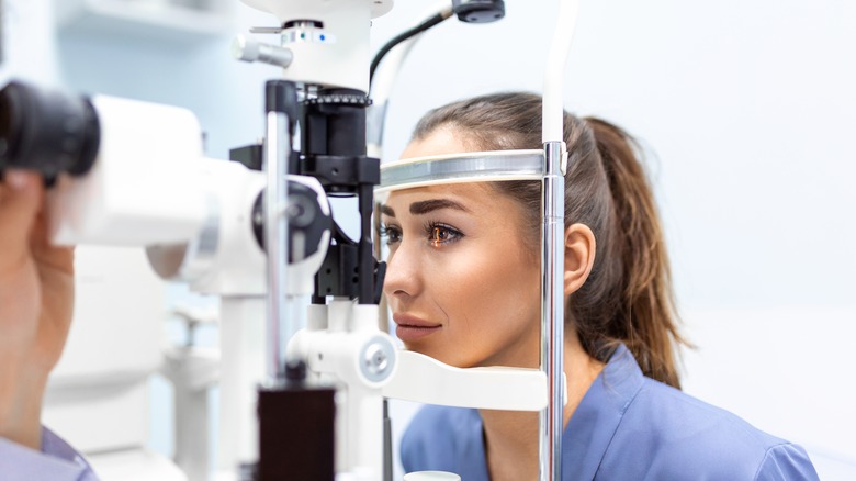 Woman at eye doctor getting eye exam