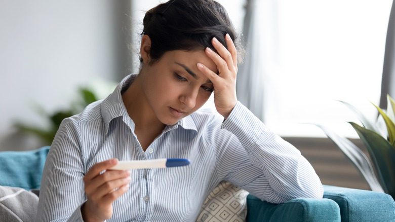 women frustrated at negative pregnancy test