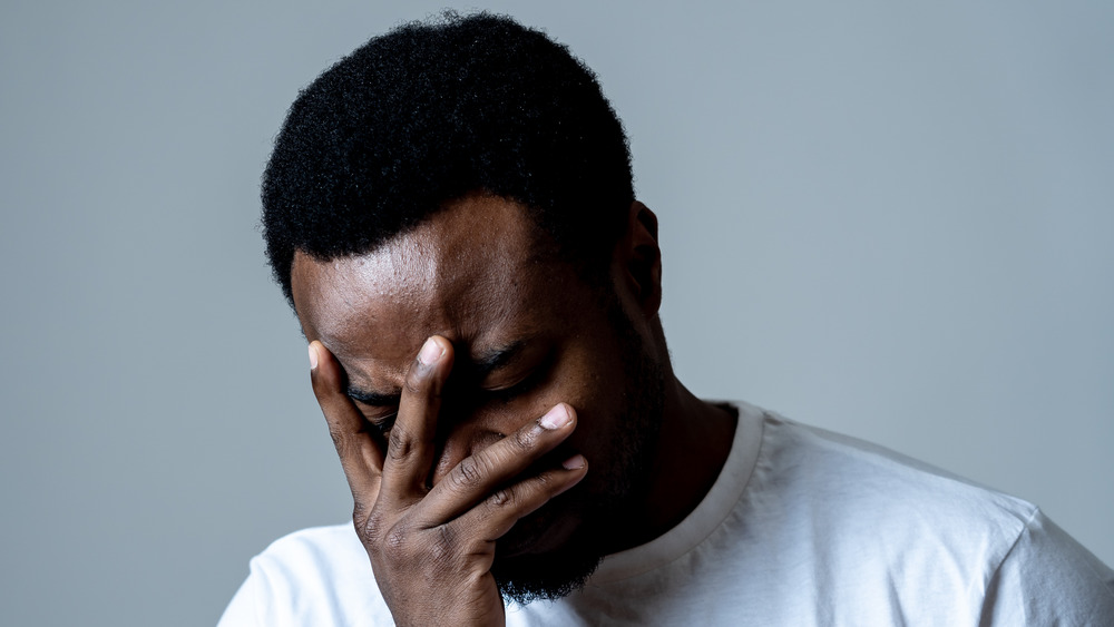 Depressed man hold his head 