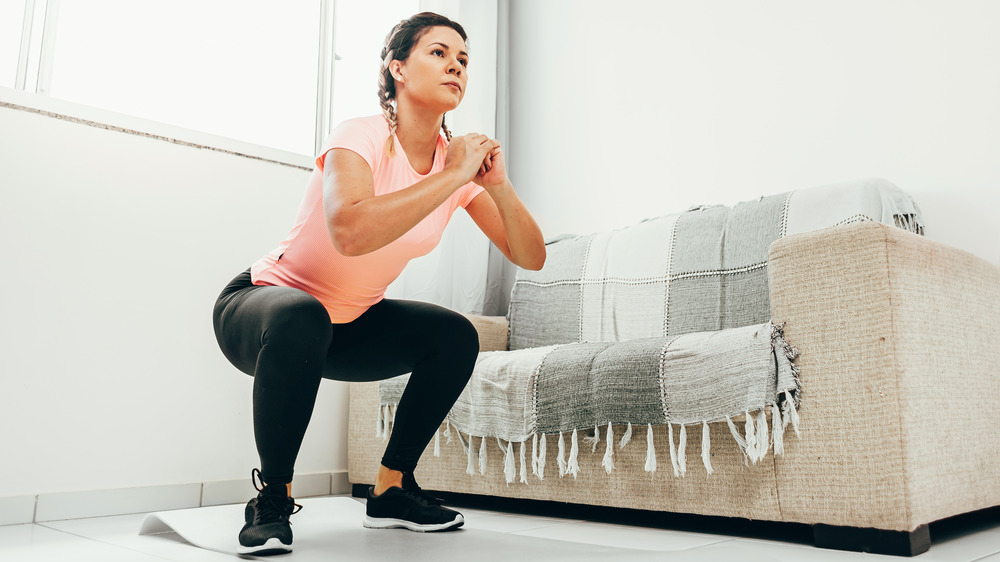 Woman holding squat exercise posititon